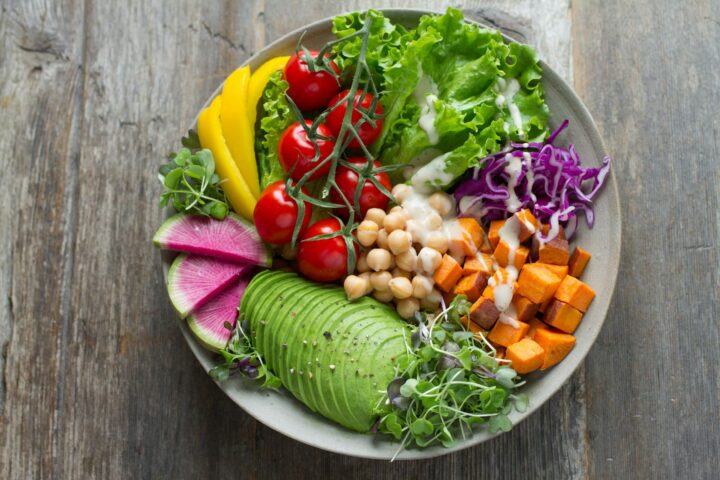 Colorful nutrient-rich buddha bowl with avocado, chickpeas, sweet potato, and vegetables, representing healthy eating that supports addiction recovery