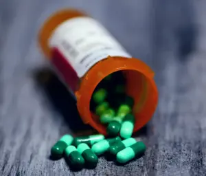 Pill bottle spilling out pills on the table representing gabapentin.